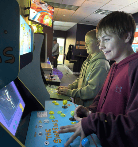 Kids playing together in The Basement arcade