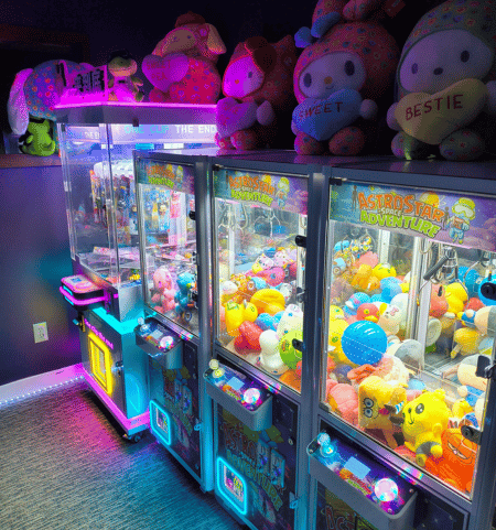 Colorful claw machines filled with prizes
